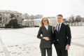 The businessman and the secretary walk along the city streets during a break from work