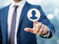 Businessman selects a user profile icon with his index finger on a digital interface Royalty Free Stock Photo