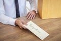 Businessman sending letter will being resignation and carrying packing belongings company and files into brown cardboard box, Royalty Free Stock Photo