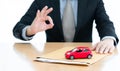 A Businessman sent filing for car loan. document and small red car