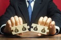 Businessman separates the wooden puzzle with a picture of money. The concept of financial management and distribution of funds.