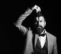 Businessman with serious face isolated on black background. Macho in formal suit shaves beard. Man with long beard Royalty Free Stock Photo