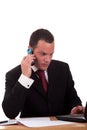 Businessman setting a desk talking on the phone