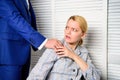 Businessman Sexually Harassing Female Colleague. Person putting hand on shoulder. Touch knee. Royalty Free Stock Photo