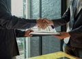 Businessman shakehand and exchanging contract documents Royalty Free Stock Photo