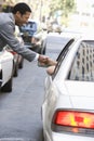 Businessman Shaking Hand With A Person In Car Royalty Free Stock Photo