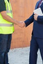Businessman Shaking Hands With Builder On Construction Site Royalty Free Stock Photo