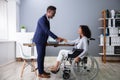 Businessman Shaking Hands With Disabled Businesswoman Royalty Free Stock Photo