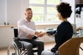 Businessman Shaking Hands With Disabled Businesswoman Royalty Free Stock Photo