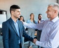 Businessman Shaking Hands With Employee In Modern Office