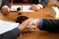 businessman shaking hands with lawyer after discussing auction c