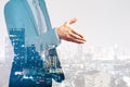 Businessman shaking hands on night city background. Teamwork, success and partnership concept. Double exposure Royalty Free Stock Photo