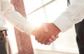 Closeup of a business handshake, on bright background Royalty Free Stock Photo