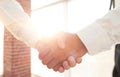 Closeup of a business handshake, on bright background Royalty Free Stock Photo