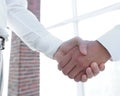 Closeup of a business handshake, on bright background Royalty Free Stock Photo