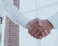 Closeup of a business handshake, on bright background Royalty Free Stock Photo