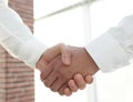 Closeup of a business handshake, on bright background Royalty Free Stock Photo