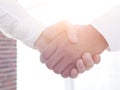 Closeup of a business handshake, on bright background Royalty Free Stock Photo