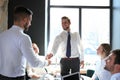 Businessman shaking hands to seal a deal with his partner and colleagues in office Royalty Free Stock Photo