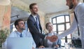 Businessman shaking hands to seal a deal with his partner and colleagues in office Royalty Free Stock Photo