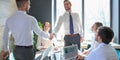 Businessman shaking hands to seal a deal with his partner and colleagues in office Royalty Free Stock Photo