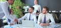 Businessman shaking hands to seal a deal with his partner and colleagues in office Royalty Free Stock Photo