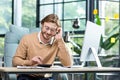 Businessman in shirt doing paperwork, man working with documents, contracts and bills sitting at table using laptop at Royalty Free Stock Photo