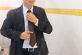 Businessman in shirt dressing up and adjusting tie Royalty Free Stock Photo