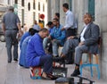 Businessman and shoe-shiner Royalty Free Stock Photo