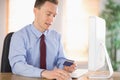 Businessman shopping online at desk