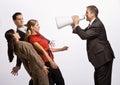 Businessman shouting at co-workers with megaphone Royalty Free Stock Photo