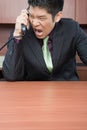 Businessman shouting down phone Royalty Free Stock Photo