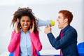 Businessman shouting megaphone to african woman Royalty Free Stock Photo