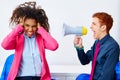 Businessman shouting megaphone to african woman Royalty Free Stock Photo