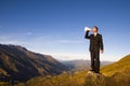 Businessman Shouting on the Top of the Mountain