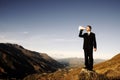 Businessman Shouting on the Top of the Mountain