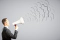 Businessman shouts through megaphone Royalty Free Stock Photo