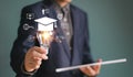 Businessman show light bulb graduation hat. Study E-learning graduate certificate program concept. Royalty Free Stock Photo