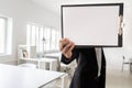 Businessman showing a blank piece of paper on a clipboard