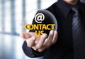 Businessman showing contact us text in crystal ball Royalty Free Stock Photo