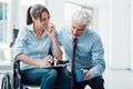 Businessman showing a document to a woman in wheelchair Royalty Free Stock Photo