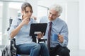 Businessman showing a document to a woman in wheelchair Royalty Free Stock Photo