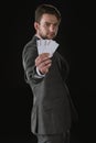 Businessman showing Joker cards isolated on black