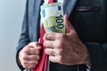 Businessman showing off with money, swagger entrepreneur holding bunch of hundred euro banknotes