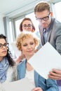 Businessman showing photograph to colleagues in creative focus