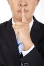 Businessman showing quiet gesture