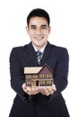 Businessman showing small house Royalty Free Stock Photo