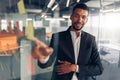 Businessman showing on sticky notes on glass wall while working in modern office Royalty Free Stock Photo