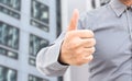 Businessman showing thumbs up sign standing in office Royalty Free Stock Photo