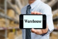 Businessman showing warehouse wording